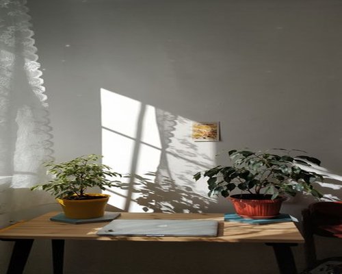 Bright sunny day in Arequipa, casting strong light onto a home office desk