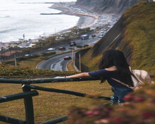 Person walking on the Miraflores boardwalk during a cloudy afternoon in Lima