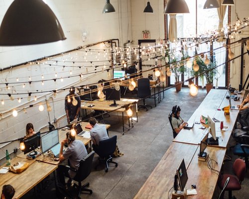 Small team of content creators collaborating in a modern coworking space