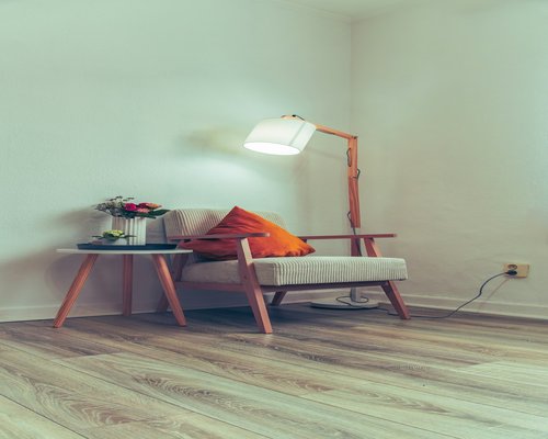 Detail of a cozy reading corner with a soft lamp illuminating an open book